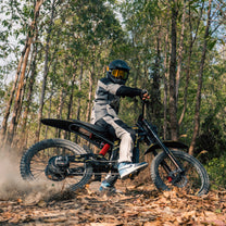 Hombre montando la bicicleta eléctrica ZONVEER ZX3 vista de lado en el bosque