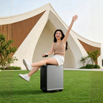 Persona sentada en la maleta eléctrica montable Air Pro Edition al aire libre