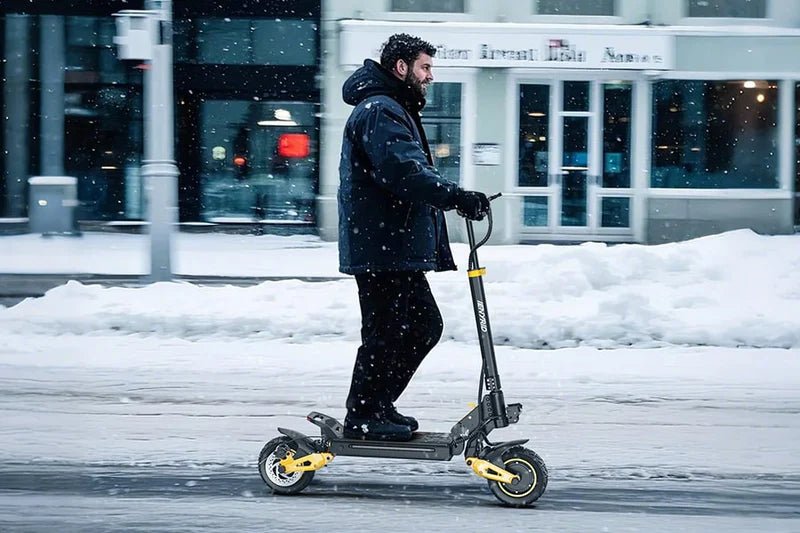 Hombre montando el patinete eléctrico iENYRID ES1 en la nieve