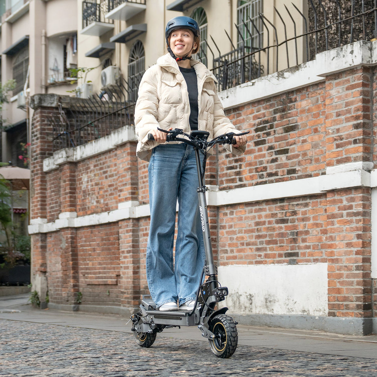 Mujer montando el patinete eléctrico iENYRID S1 por una calle