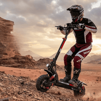 Persona de pie junto al patinete eléctrico iScooter GX3 Pro sobre terreno arenoso