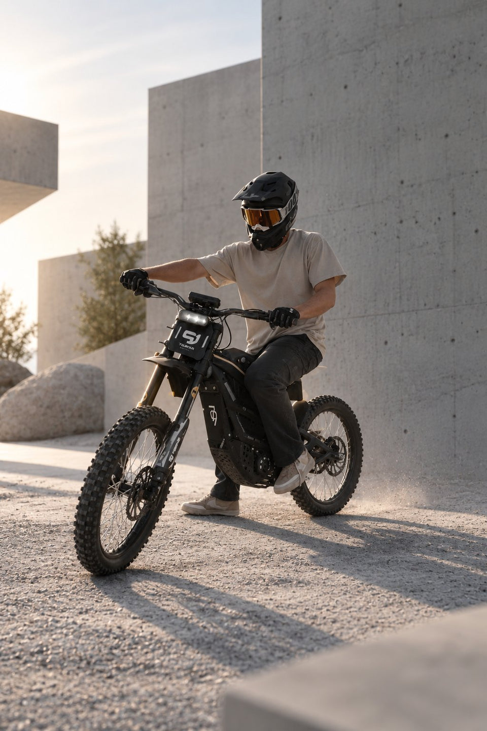 Moto cross eléctrica de Wheelyshop – piloto con casco integral frente a arquitectura moderna de hormigón